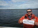 Jim working with a flat alewife and NOAA to deploy acoustic telemetry receivers in Merrymeeting Bay