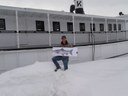 U.S. Fish and Wildlife Service biologist Mark McCollough with the flat salmon on Moosehead Lake. Mark is standing next to steamship Katahadin with the lake in the background.