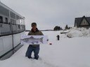 U.S. Fish and Wildlife Service biologist Mark McCollough with the flat salmon on Moosehead Lake. Mark is standing next to steamship Katahadin with the lake in the background.