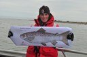 Maine Coastal Islands National Wildlife Refuge biologist, Linda Welch, proudly displays an Atlantic Salmon at Petit Manan Point.