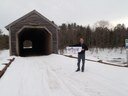 Thomas Davidowicz, a U.S. Fish and Wildlife Service biologist, at the historic Low's Bridge on the Piscataquis River in Guilford with our flat salmon!
